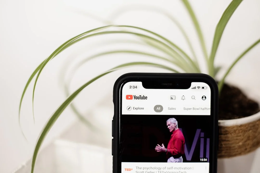 Des mains tenant un smartphone avec une application boursière, et un ordinateur portable affichant des graphiques. Idéal pour les univers de la finance et de la technologie.